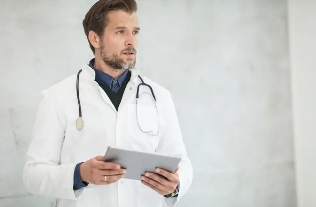 Doctor reviewing patient information on a tablet