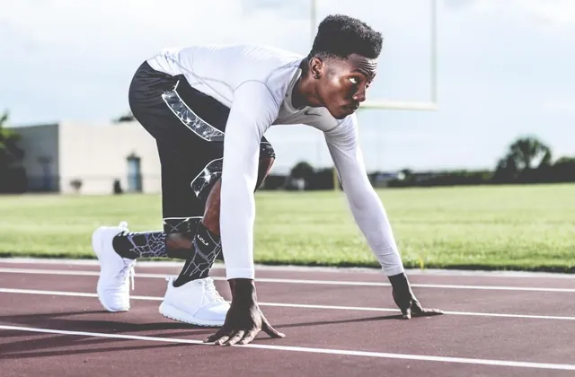 Man at the starting line of a running track for men's fitness