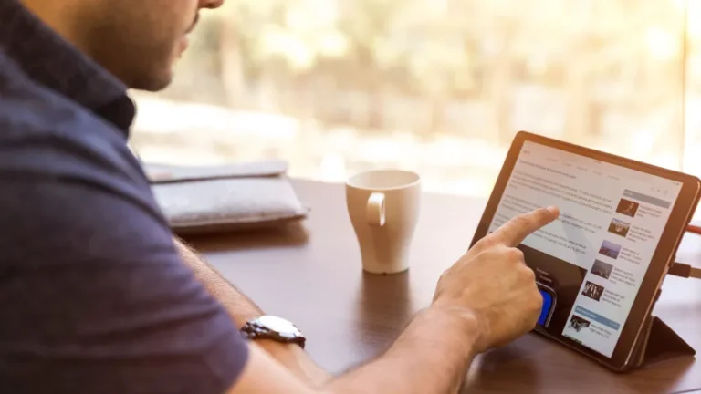 Man reading health guides on a tablet with coffee